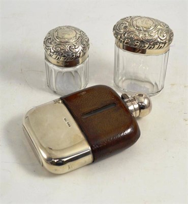 Lot 190 - A hunting flask with silver pull off cup and silver lid, James Dixon & Sons, also two silver topped