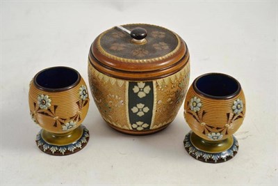 Lot 191 - A Royal Doulton tobacco jar and two Royal Doulton match strikers (3)