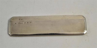 Lot 201 - A pocket comb in an engine turned silver case, Birmingham, 1913, maker's mark EJ Trevitt & Sons