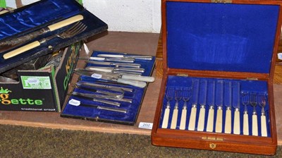 Lot 202 - A cased set of six silver handled tea knives, six uncased examples, two silver cake knives with...