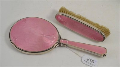 Lot 216 - Art Deco silver and pink enamel hand mirror and clothes brush (2)