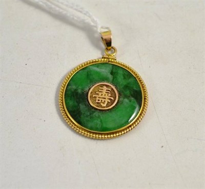 Lot 220 - Chinese jadeite pendant in gold circular mount stamped 14K