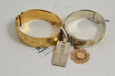 Lot 228 - A silver ingot, a 9ct gold pendant on chain, a silver bangle with leaf decoration, a rolled...