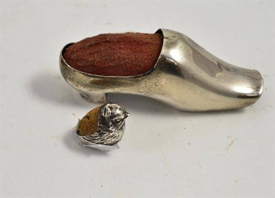 Lot 241 - A Sampson & Mordon novelty silver pin cushion as a chick and another as a boot