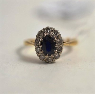 Lot 248 - A sapphire and diamond cluster ring