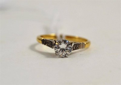 Lot 265 - A diamond solitaire ring with diamond set shoulders, stamped 18ct