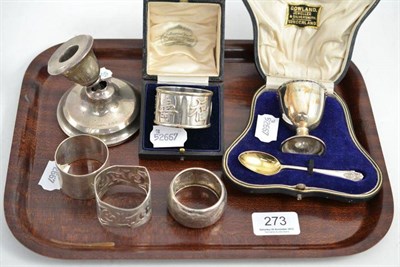 Lot 273 - A cased silver egg cup and spoon; a cased Chinese napkin ring; three silver napkin rings and a...