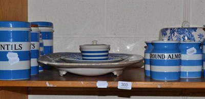 Lot 303 - A shelf of ceramics including Greener & Co Cornishware storage jars, blue and white meat dish and a