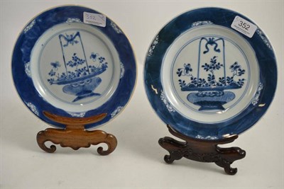 Lot 352 - A pair of 18th century Chinese blue and white plates on hardwood stands