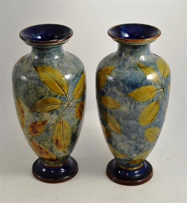 Lot 362 - A pair of Royal Doulton stoneware vases decorated with autumnal leaves