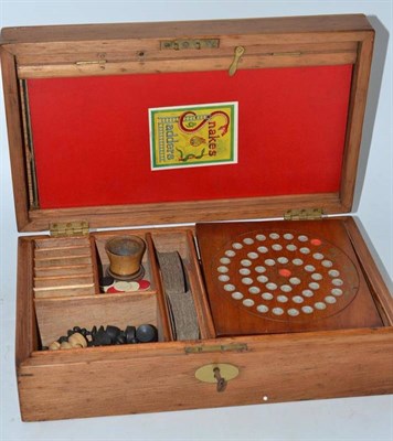 Lot 364 - An early 20th century pine cased games compendium with solitaire board, chess set, cards, etc