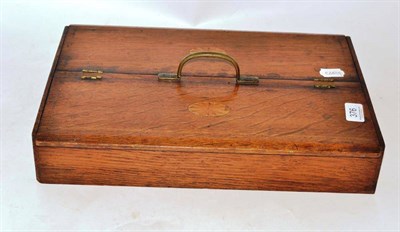 Lot 376 - An oak cutlery tray with hinged lid