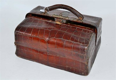 Lot 384 - A crocodile skin Gladstone style bag applied with an EW white metal monogram