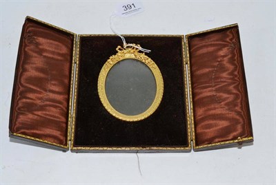 Lot 391 - A leather photograph frame with gilt tooled edges and an elaborate gilt metal interior frame