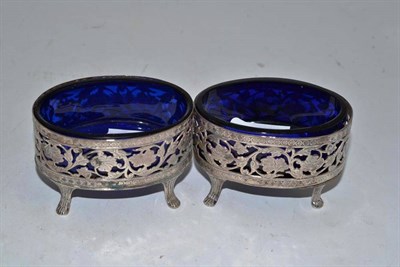 Lot 403 - Pair of oval silver salts with pierced decoration and blue glass liners