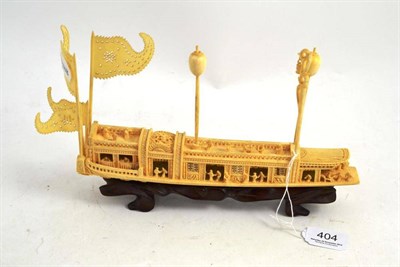 Lot 404 - A carved ivory boat on hardwood stand (pre-1950)