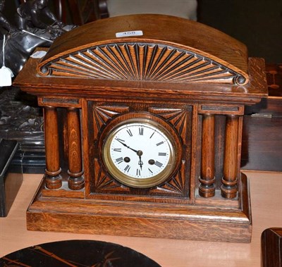 Lot 458 - An oak mantel clock and key