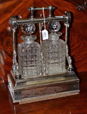 Lot 461 - Plated two bottle tantalus with cut glass decanters and stoppers