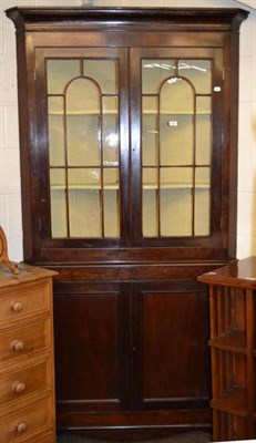 Lot 543 - A large Georgian mahogany free standing corner cupboard with glazed top