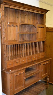 Lot 548 - A modern pine Welsh dresser with plate rack and carvings