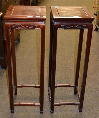 Lot 557 - A pair of Chinese carved plant stands