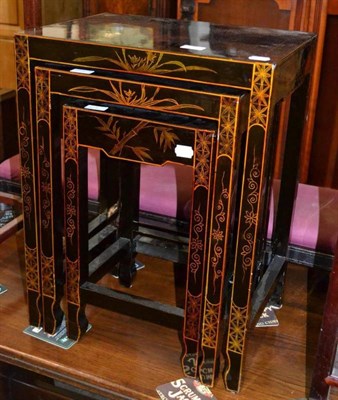 Lot 558 - A nest of three Chinese style lacquered tables