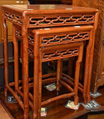 Lot 561 - A nest of three Chinese hardwood occasional tables