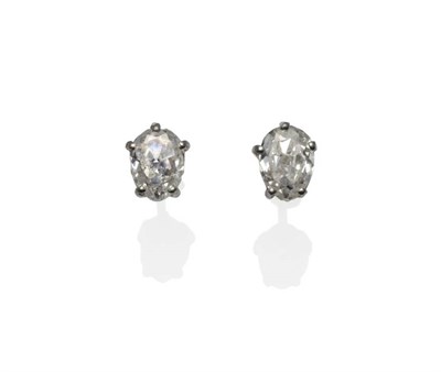 Lot 233 - A Pair of Diamond Solitaire Earrings, an old pear cut diamond in a white claw setting, total...