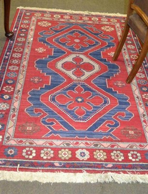 Lot 568 - Red ground rug with blue central field