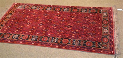 Lot 587 - Beshir rug, Afghan Turkestan, the claret field with columns of hooked motifs enclosed by leaf...