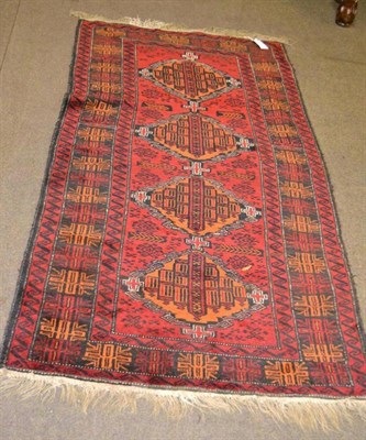 Lot 588 - Balouch rug, West Afghanistan, the blood red field with four medallions framed by arrowhead...