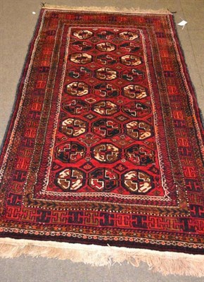 Lot 612 - Balouch rug, Persian/Afghan Frontier, the crimson field with three columns of quartered guls, 205cm