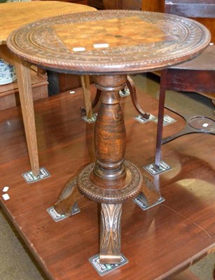 Lot 618 - Carved games table on a tripod base