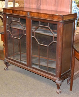 Lot 620 - A mahogany and walnut inlaid glazed bookcase on claw and ball feet