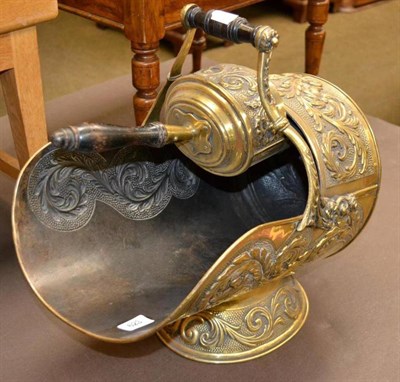 Lot 623 - An embossed brass coal bucket