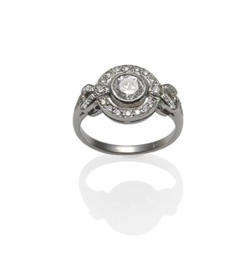 Lot 240 - An Art Deco Diamond Ring, an old cut diamond centrally, claw set to diamond set geometric shoulders
