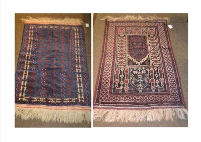 Lot 646 - Balouch prayer rug, the deep indigo field with rows of stylised trees beneath the Mihrab...