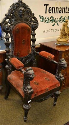 Lot 655 - A 19th century heavily carved oak open armchair