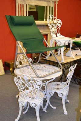 Lot 739 - A modern white painted cast iron garden table, four similar chairs, a marble top garden table and a