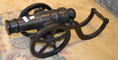 Lot 794 - A 19th century small black painted cast iron signal cannon, the 39cm double ringed barrel with...