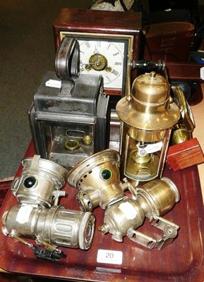 Lot 20 - Two brass carbide cycle lamps, a small brass carriage lamp, two other lanterns and a drop dial...