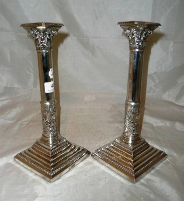 Lot 40 - A pair of silver Corinthian column candlesticks