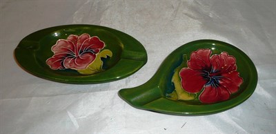 Lot 54 - Two Walter Moorcroft 'Hibiscus' green ground oval dishes