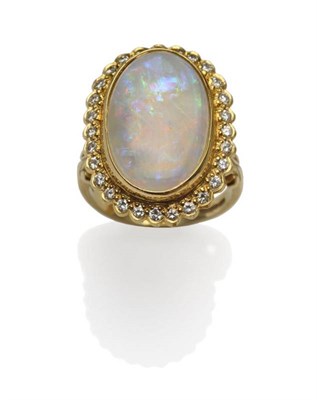 Lot 261 - An 18 Carat Gold Opal and Diamond Cluster Ring, the oval cabochon opal within a border of round...