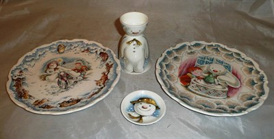 Lot 56 - Two Royal Doulton 'Snowman' plates and a 'Snowman' egg cup and saucer/hat
