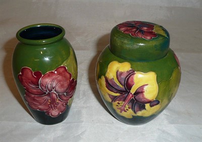 Lot 59 - A Walter Moorcroft 'Hibiscus' green ground vase and cover and a matching vase