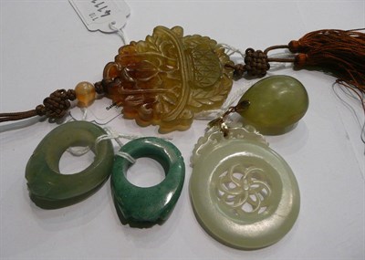 Lot 106 - Two gold mounted jade pendants, two stone rings and a carved pendant with tassel