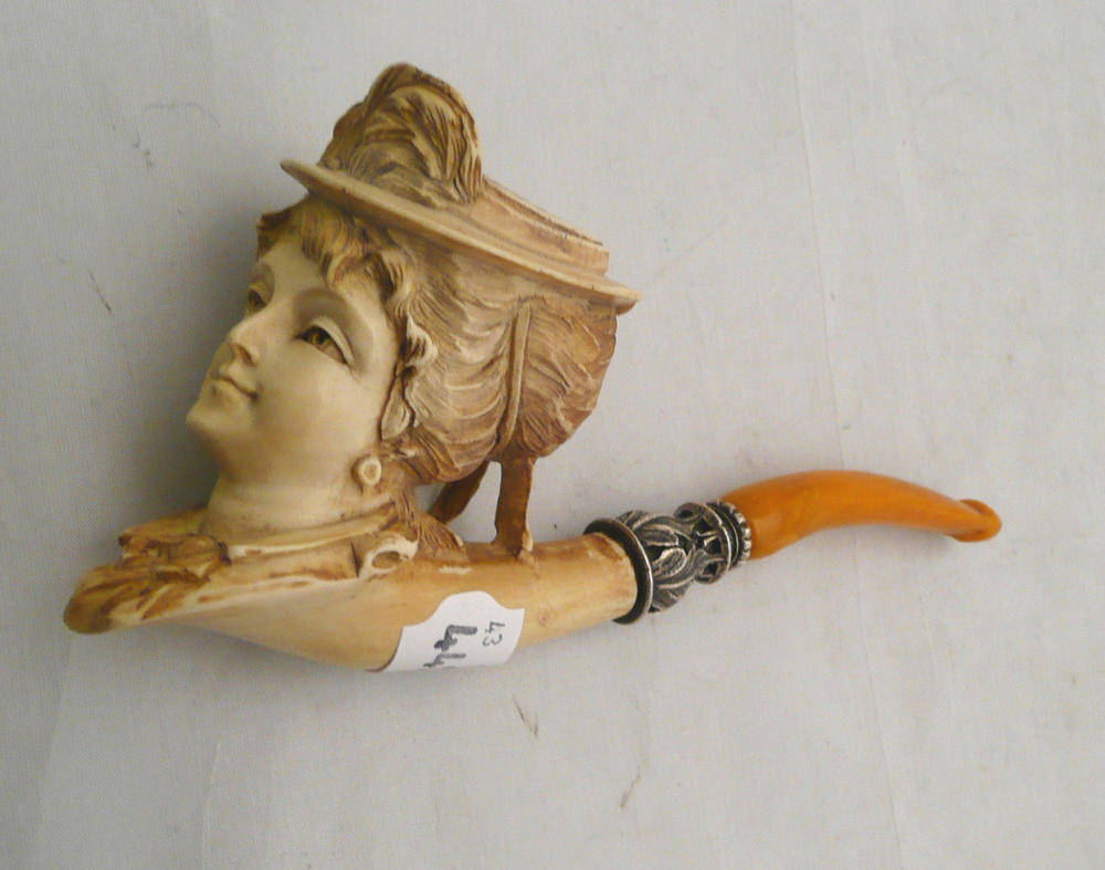 Lot 121 - A Victorian Meerschaum pipe with amber mouth piece depicting a lady in a plumed hat