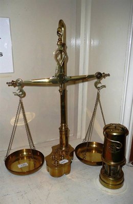 Lot 130 - A set of reproduction brass pan scales, the base fitted with graduated weights and a modern...