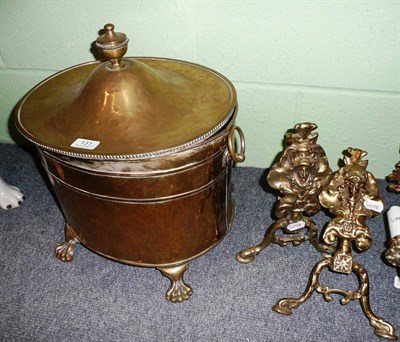 Lot 131 - A brass coal scuttle and two fire dogs